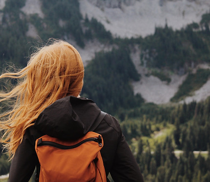 A girl looking at the mountains