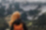Back of a woman looking at a mountain, symbolizing growth, aspiration, and healing at Creating Space Therapy.