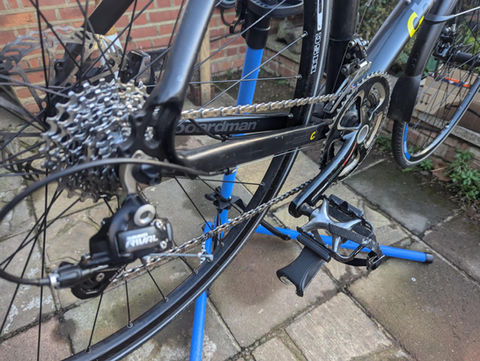 Close-up of a Boardman bicycle undergoing a Gold service in Egham, featuring a replacement of tyres, chain, cassette, cables, brake pads, and brake internals. Additional work includes brake bleeding to ensure optimal performance.