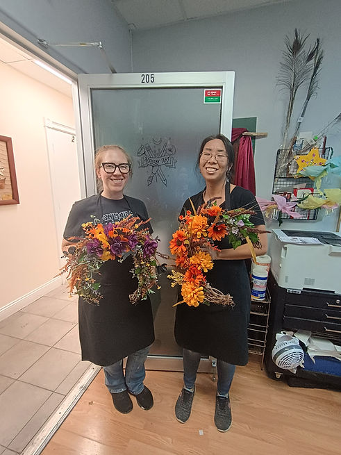 Co-Owners, Samantha White and Satsuki Gormley, pose with their creations.