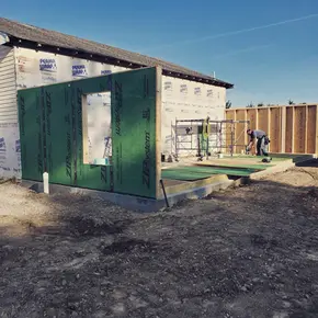 Home addition construction with drywall hanging in progress.