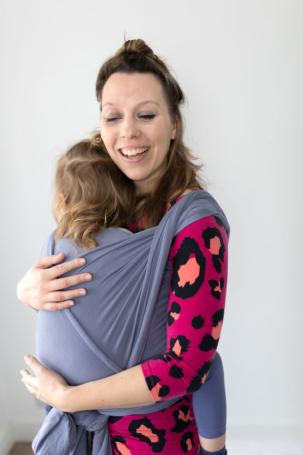 Emma from Little One Snug with her little girl in a carrier.