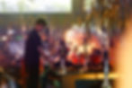Hookah master preparing premium shisha for guests inside a cozy lounge with ambient lighting