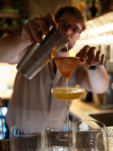 Bartender mixing handcrafted cocktails at Hubble Bubble Lounge in Hallandale Beach.
