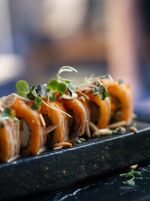 Guests enjoying sushi and wine specials at HB Lounge Bar in North Miami Beach