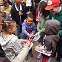 Show people giving shoes to kids.jpg