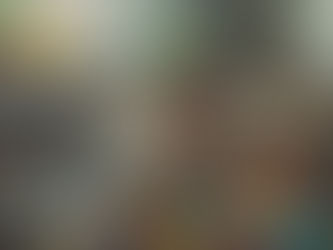 A woman sitting on a couch feeling overwhelmed, holding her baby.