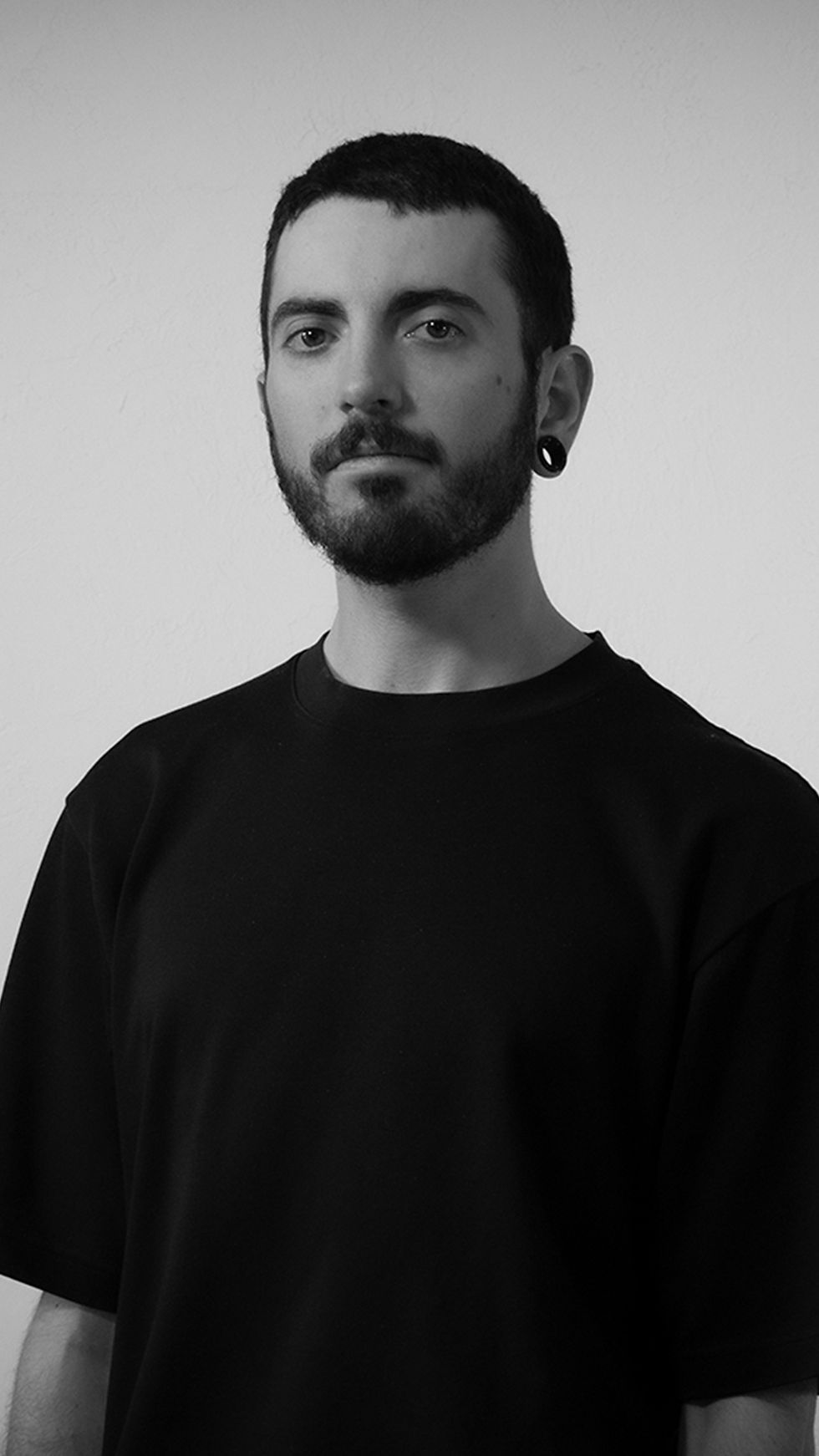 Black-and-white portrait of Jean-Philippe Jullin with short hair and a beard, looking at the camera.