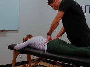 Physical therapist working with a patient on back pain recovery through movement and loading at Made 2 Move PT