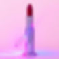 lipstick futuristic wand, stands alone in image with red and blue stage lights, zoom close