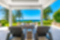 Luxury view home deck with ocean view fireplace hot tub and patio furniture.jpg