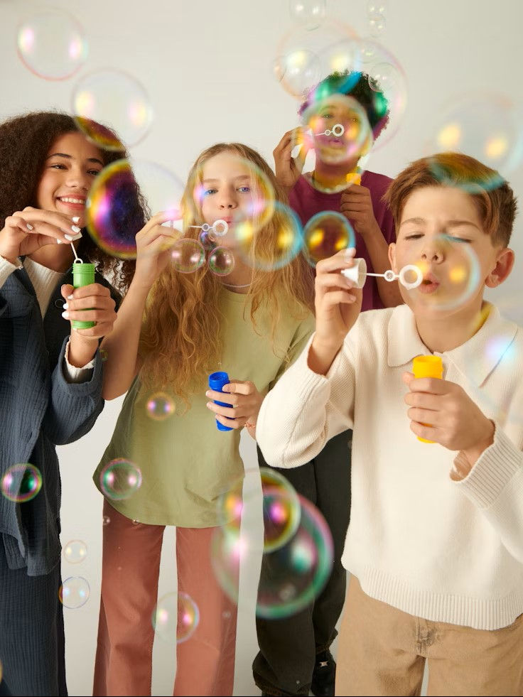 Children blowing bubbles