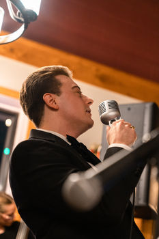 Drew Lafferty holding a microphone.