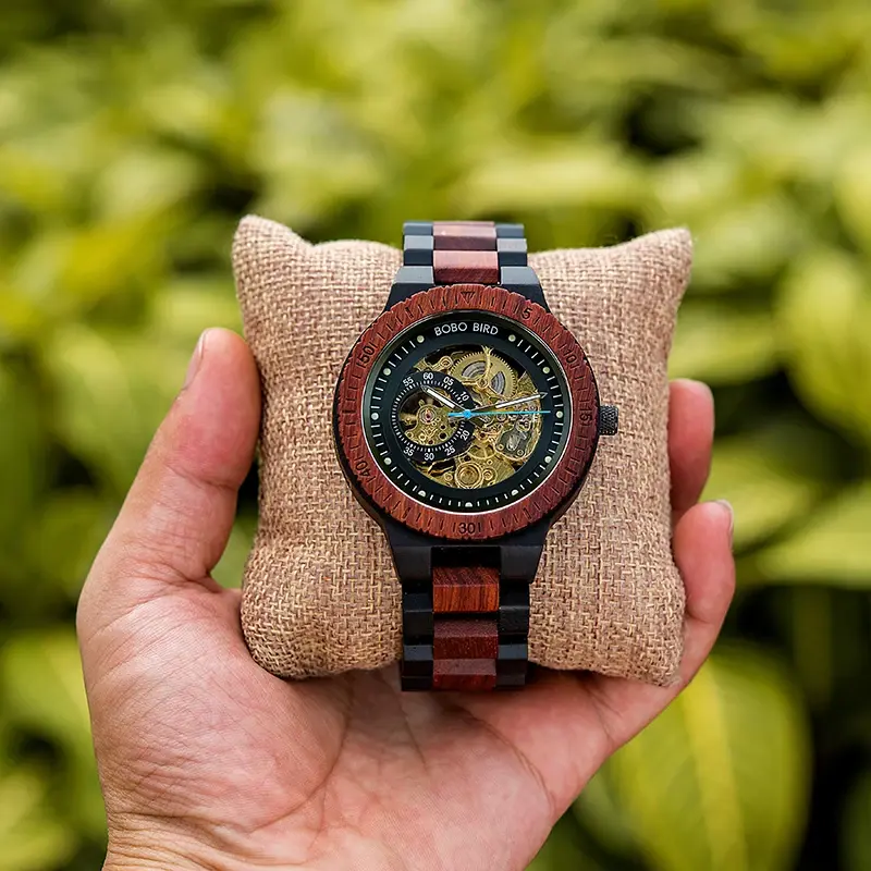 Thumbnail: Hand holding wooden watch with skeletal dial