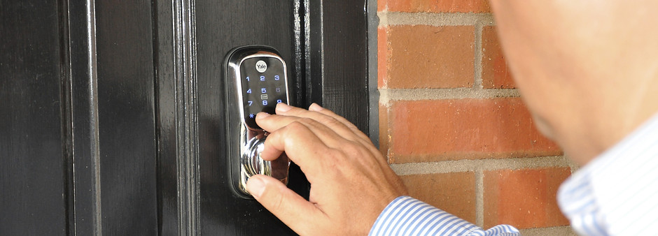 Image showing a home owner opening the keyless lock with a pin code