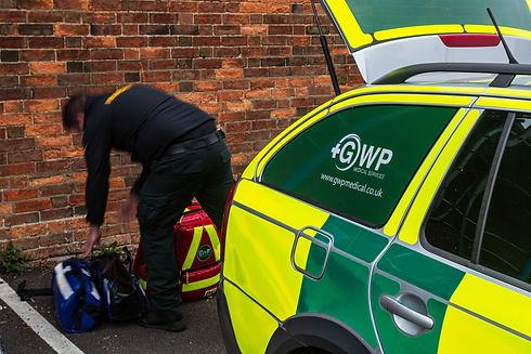 man taking things out of car boot