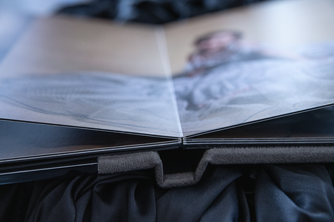 a seamless center photo album on a black satin backdrop