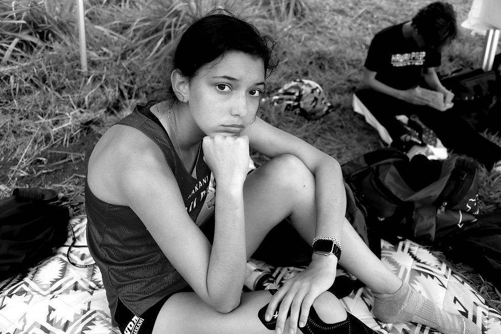 Elaina before putting on compression socks and running the 400m race that day. One leg already taped up with KT tape. March 19, 2022