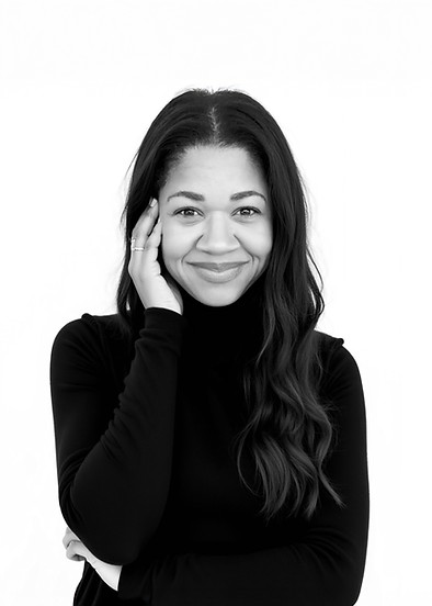 woman holding hand to face in black and white