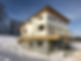 Custom design build home surrounded in snow.