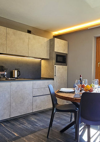 Modern kitchen and living room in Apartment Domenico, holiday apartment in the centre of Livigno with mountain views.