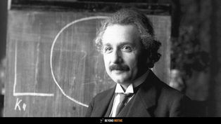 Black and white portrait of Albert Einstein standing in front of a chalkboard with a drawn circle, symbolizing his groundbreaking work in physics and relativity