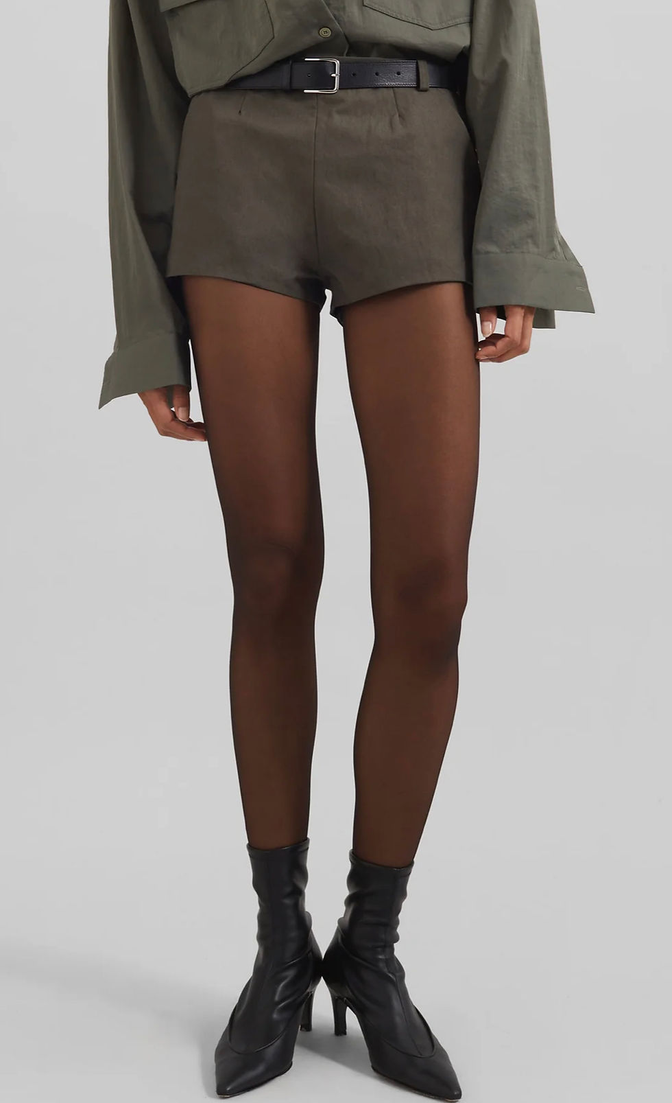 Olive beige micro shorts, tailored with a black belt.