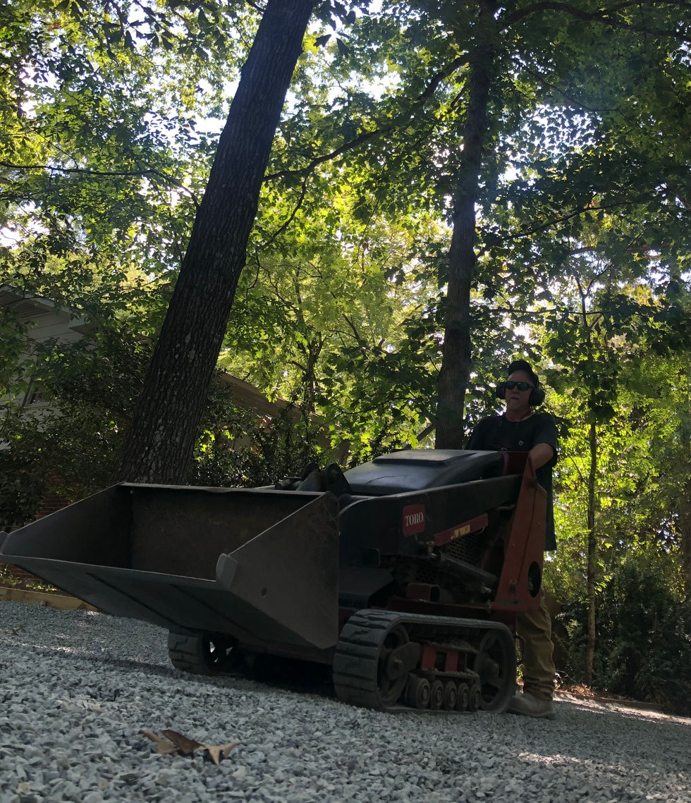Using a dingo to add gravel to a driveway in Carrboro, NC