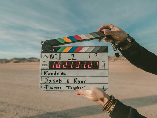 clapperboard in hands on a film set in the desert