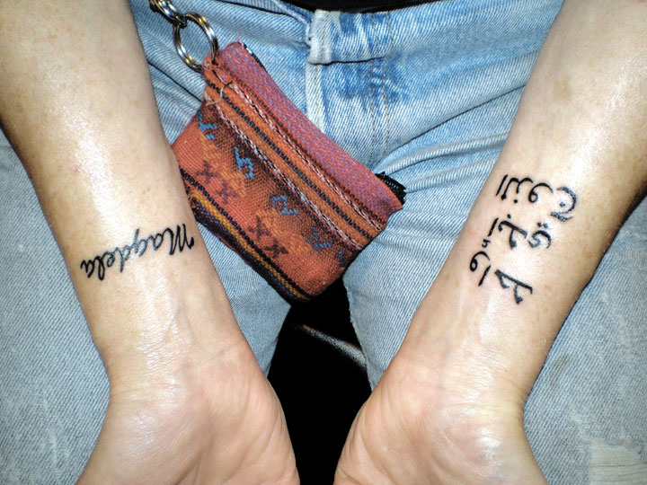 Kari gets her wrists inked.