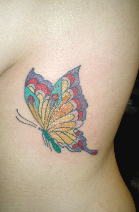 Woman and rib butterfly up close.