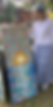 painting_sunset with artist holding it.PNG