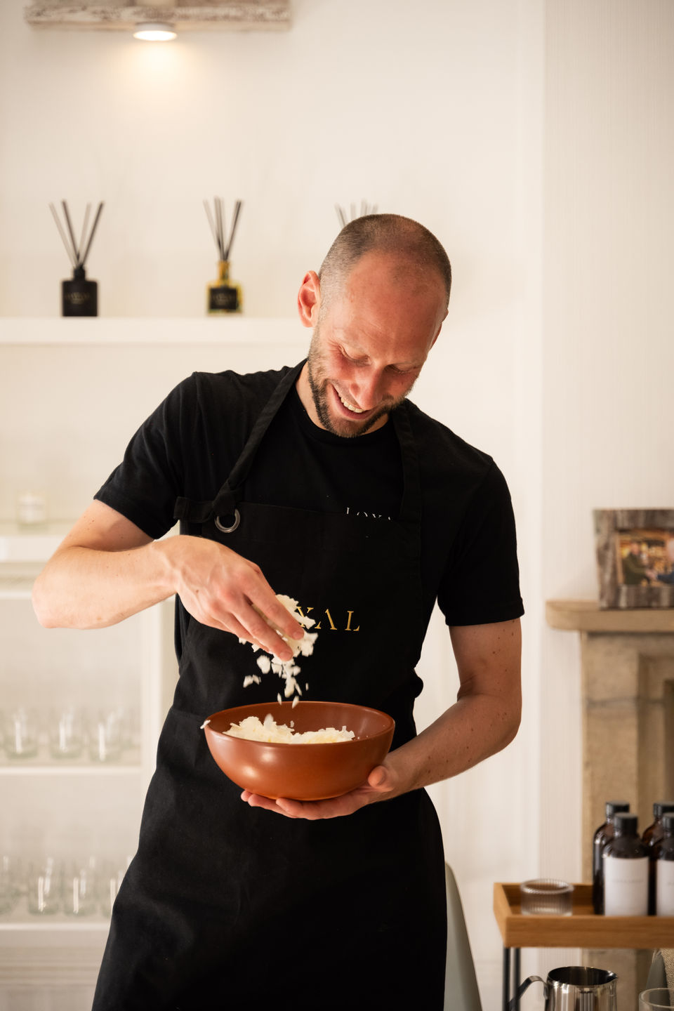 Environmental portrait of the owner of Loyal Candles in their studio. Branding photography highlighting their role as a workshop host, captured by Patryk Majewski at Patryk Creative.