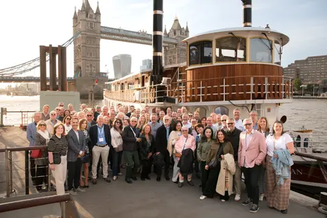 Group photo of guests boarding a boat for a corporate party in London. Professional River Thames event photography and corporate boat hire coverage by Patryk Majewski at Patryk Creative.