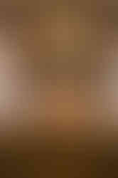 The stone fireplace decorated with candles and flowers inside the wedding venue Lily Stone gardens during a reception in winnipeg manitoba