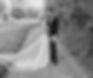 A bride and groom in elegant wedding attire hold each other in a editorial inspired pose