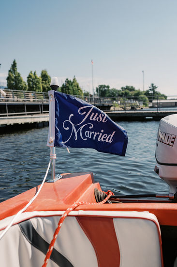 The bride and groom boat over to Royal Lake of The Woods Yacht Club