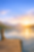 Sunrise over a peaceful lake and a dock represents a fresh perspective and reinventing yourself in retirement.