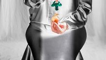A mother with a soother in her hand 