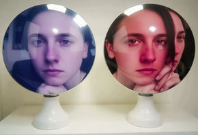 two mirrors, one reflecting an angelic face and the other reflecting a devil one