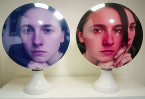 two mirrors, one reflecting an angelic face and the other reflecting a devil one