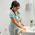 a latina woman cleaning a bathroom.jpg