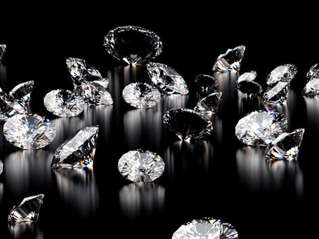 photo of diamonds scattered on a black background.