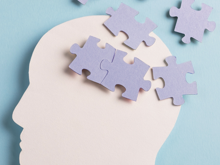 Human head silhouette with purple puzzle pieces representing cognitive load and problem‑solving
