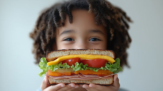 child-enjoying-colorful-ham-cheese-sandwich-with-fresh-vegetables-cheerful-expression.jpg