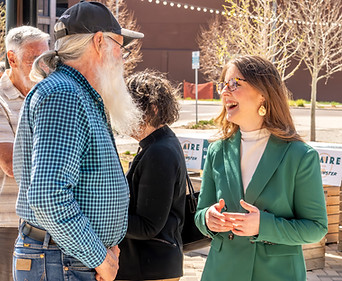 Claire talking and smiling with a voter