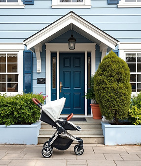 baby stroller in front of a front door to a blue and white house.jpg