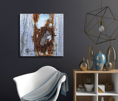 Abstract artwork in mixed media on canvas with contrasting structure in light blue and rust effects on a dark wall.