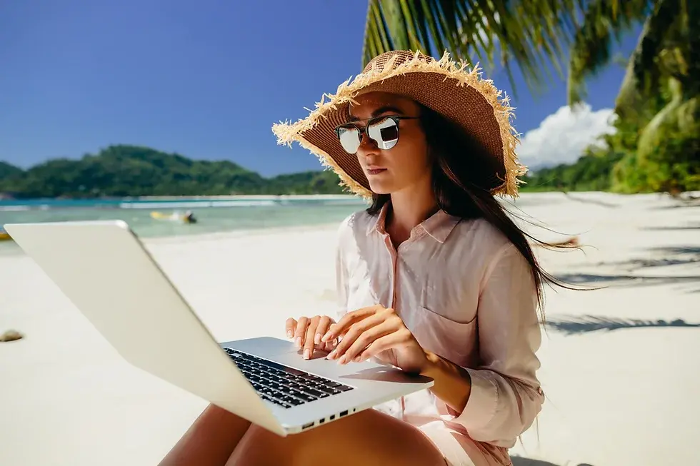 Woman using laptop on the beach