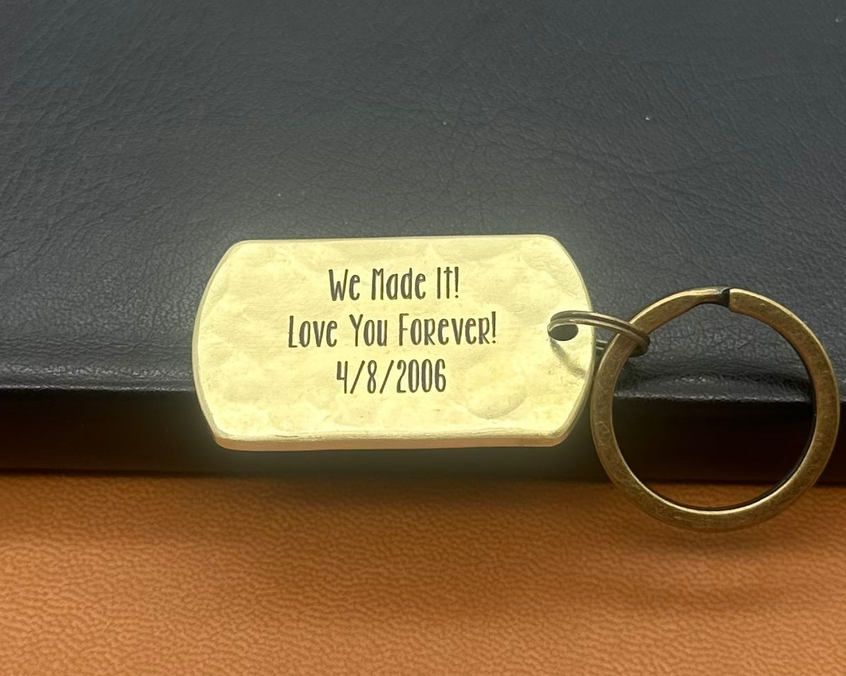 19th anniversary bronze keychain showing tally mark engraving and meaningful back inscription.